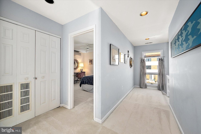 hallway featuring light carpet