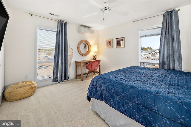 carpeted bedroom featuring ceiling fan, a wall unit AC, and multiple windows