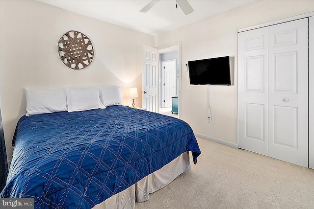 carpeted bedroom with ceiling fan and a closet