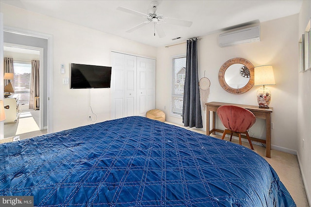 carpeted bedroom with ceiling fan, an AC wall unit, and a closet