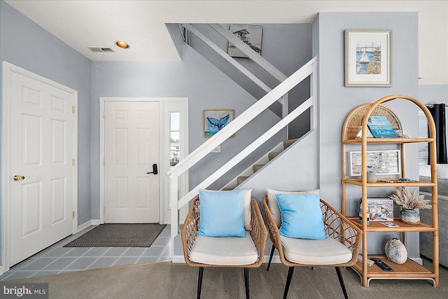 entryway featuring dark colored carpet