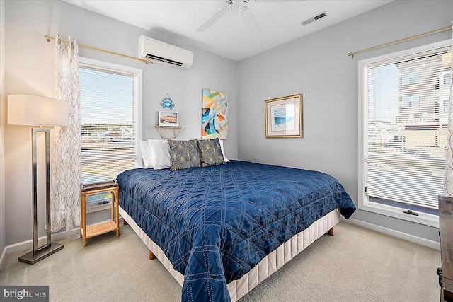 bedroom with ceiling fan, an AC wall unit, carpet floors, and multiple windows