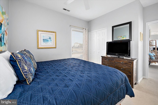 bedroom featuring ceiling fan, a closet, and carpet floors