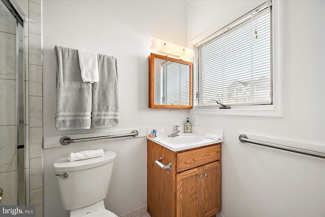 bathroom with vanity, toilet, and walk in shower