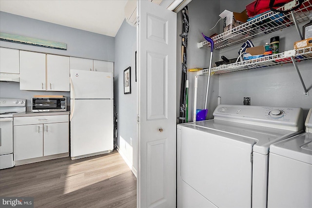 laundry room featuring washer and dryer and light hardwood / wood-style floors