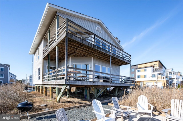 back of property with a wooden deck