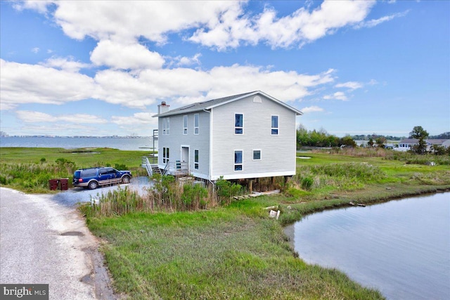 view of property exterior with a water view