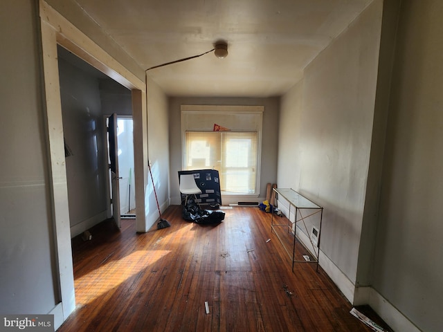 hallway featuring dark hardwood / wood-style flooring