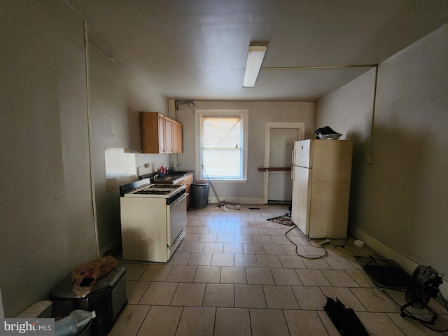 kitchen with light tile patterned flooring and white appliances