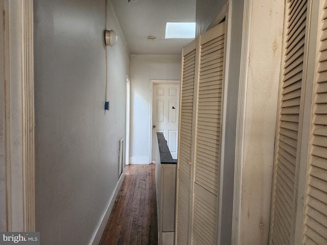 hallway with dark hardwood / wood-style floors