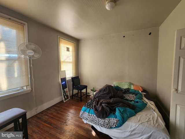 bedroom featuring dark wood-type flooring and multiple windows