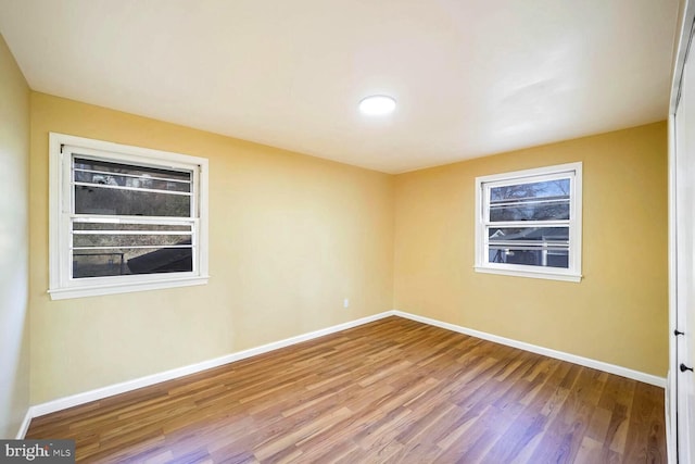 unfurnished room with light hardwood / wood-style floors and a wealth of natural light