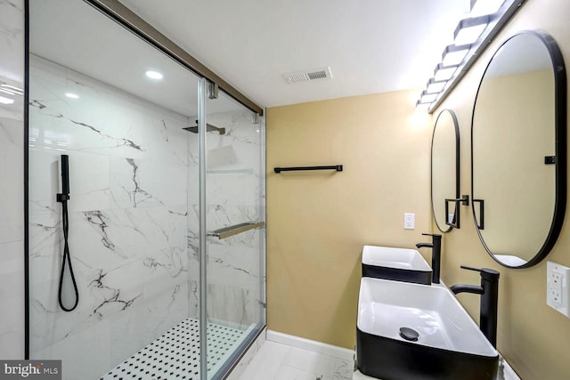 bathroom featuring walk in shower and sink