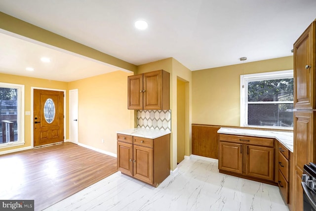 kitchen featuring beamed ceiling and tasteful backsplash