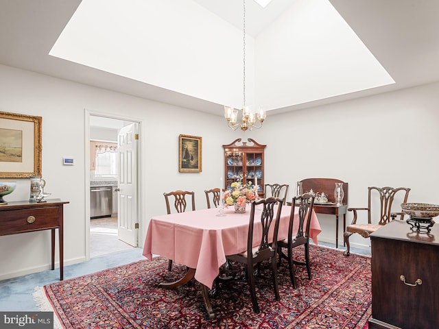 dining area with carpet and an inviting chandelier