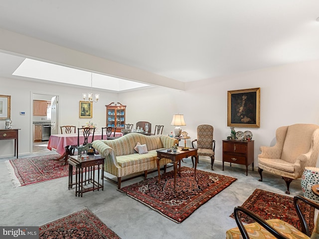 carpeted living room featuring a skylight and an inviting chandelier