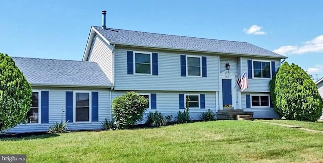 rear view of property featuring a yard