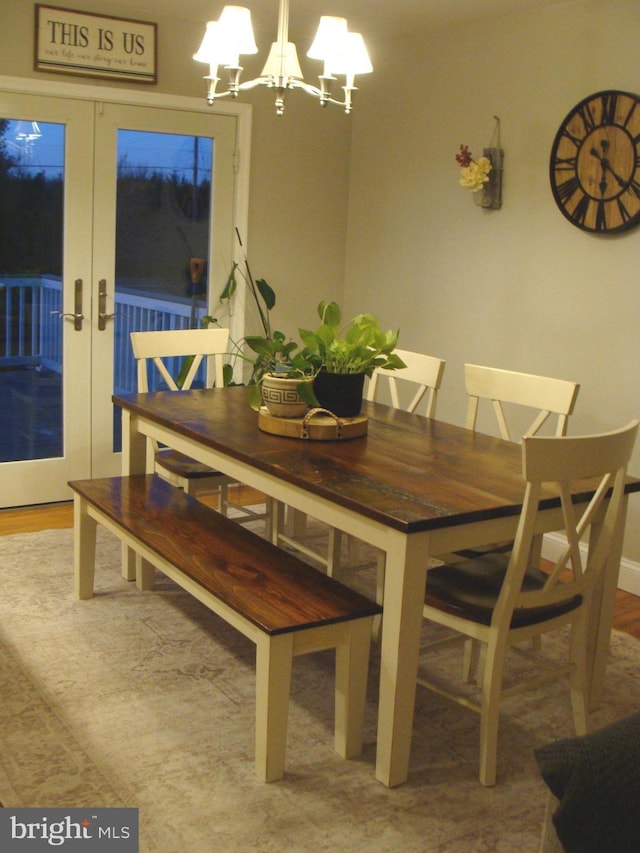 dining space with a chandelier and french doors