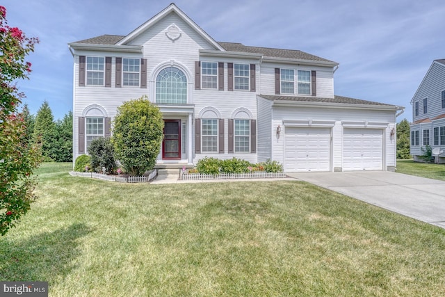 view of front of house with a garage and a front lawn