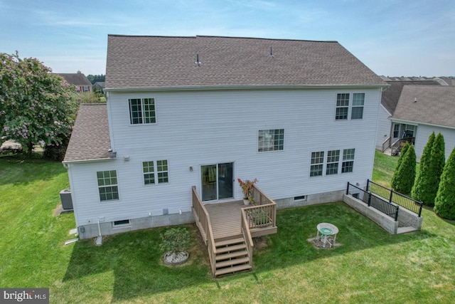 rear view of property featuring central AC, a deck, and a lawn