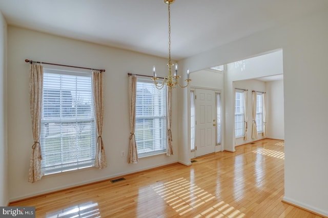 interior space featuring hardwood / wood-style floors and a notable chandelier