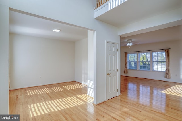 empty room featuring ceiling fan and light wood-type flooring