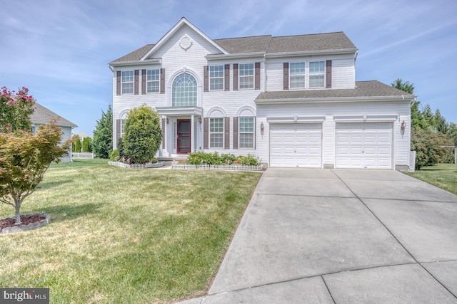 view of front of property with a front lawn and a garage