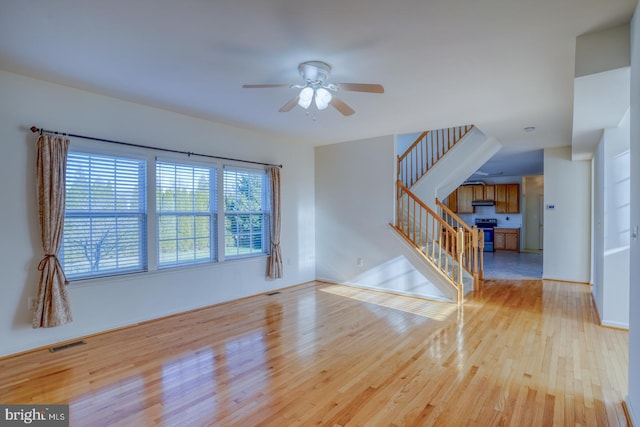 spare room featuring light wood-type flooring and ceiling fan