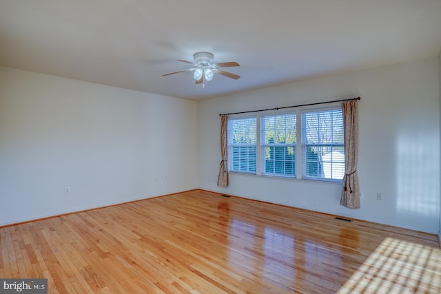 empty room featuring ceiling fan and light hardwood / wood-style floors