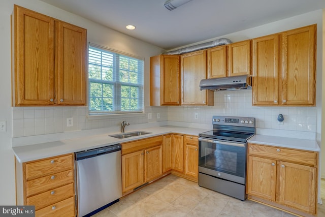 kitchen with tasteful backsplash, sink, light tile patterned floors, and stainless steel appliances