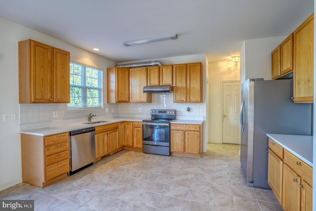 kitchen with light tile patterned flooring, appliances with stainless steel finishes, decorative backsplash, and sink