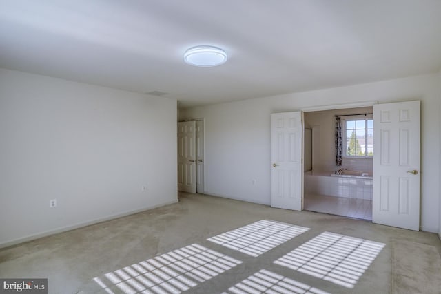 unfurnished bedroom featuring light colored carpet