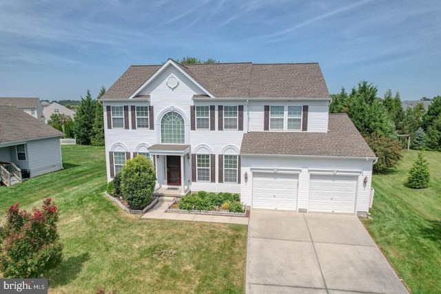 colonial home featuring a garage and a front yard