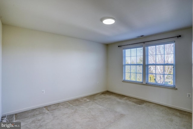 unfurnished room with light carpet