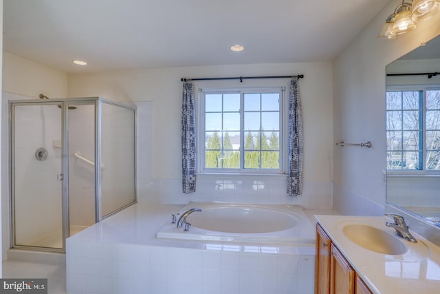 bathroom with vanity and independent shower and bath