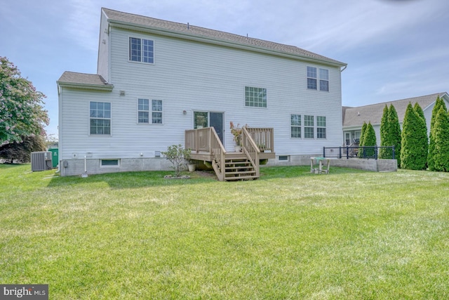 back of house featuring a lawn and central AC