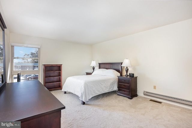 carpeted bedroom with a baseboard radiator