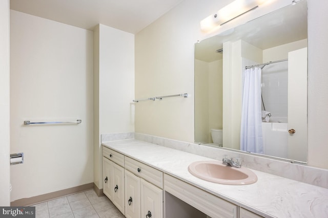 bathroom featuring walk in shower, tile patterned floors, vanity, and toilet