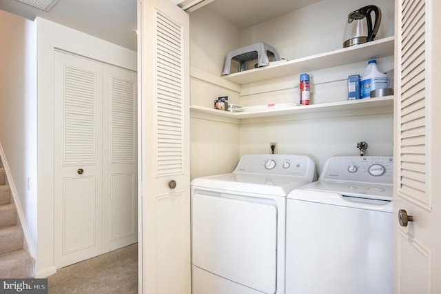 laundry room featuring separate washer and dryer and light carpet