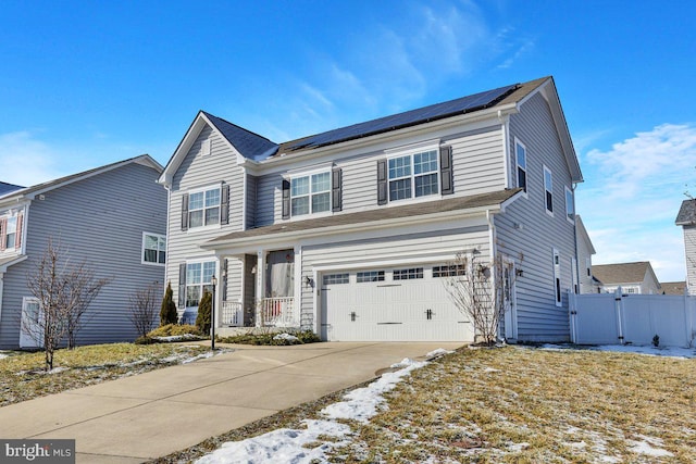 view of front of house with a garage and solar panels