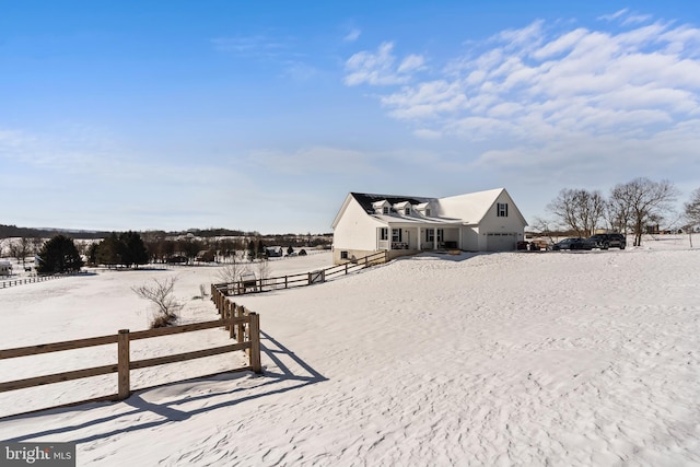 yard covered in snow featuring a rural view