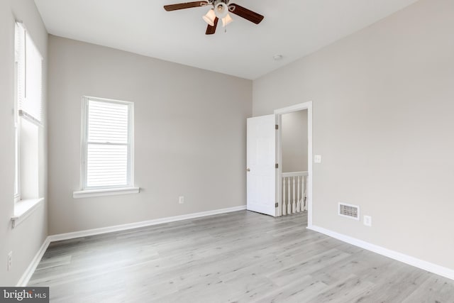 empty room featuring ceiling fan and light wood-type flooring