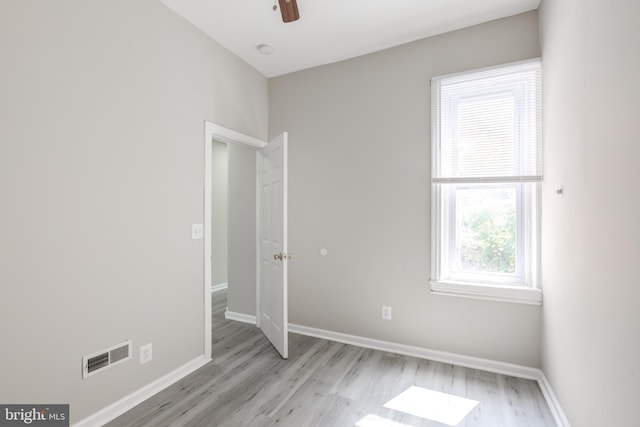 spare room with light wood-type flooring and ceiling fan