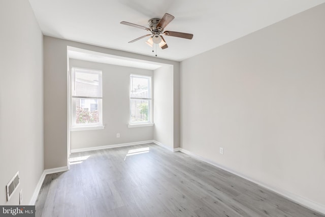 spare room featuring light hardwood / wood-style floors and ceiling fan