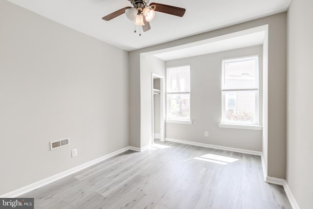 empty room featuring light wood-type flooring and ceiling fan