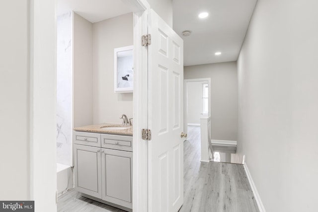 bathroom with hardwood / wood-style floors and vanity