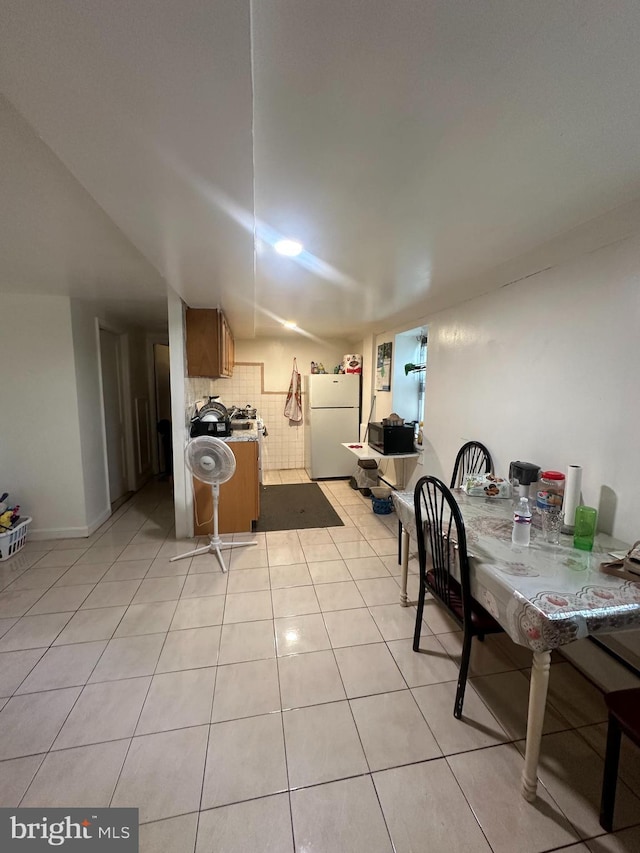 kitchen with white fridge and light tile patterned flooring