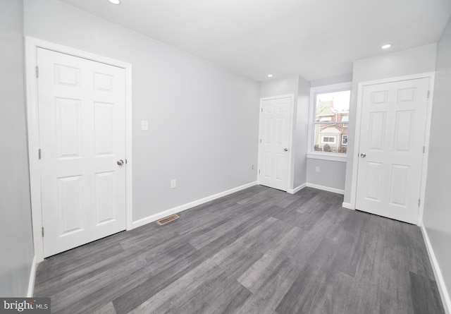 unfurnished bedroom featuring dark wood-type flooring