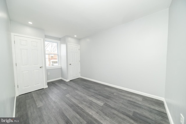 unfurnished bedroom with dark hardwood / wood-style flooring