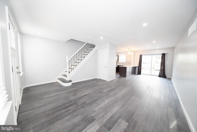 unfurnished living room featuring dark hardwood / wood-style flooring